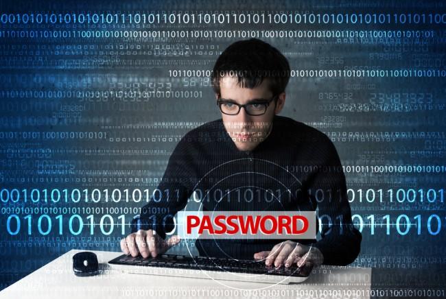 Young geek hacker stealing password on futuristic background 
